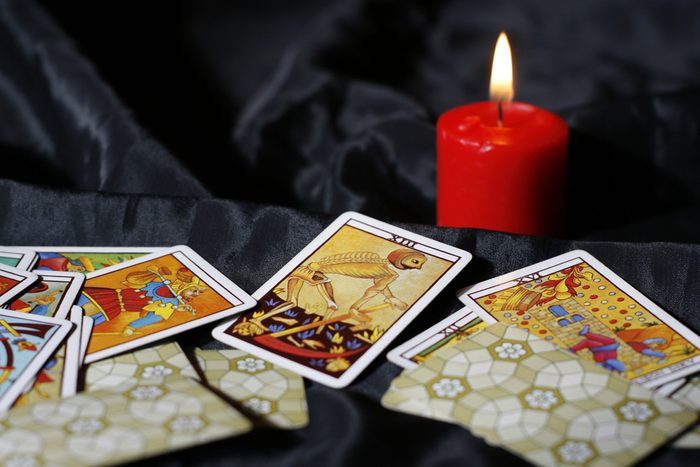 Tarot cards and burning candle