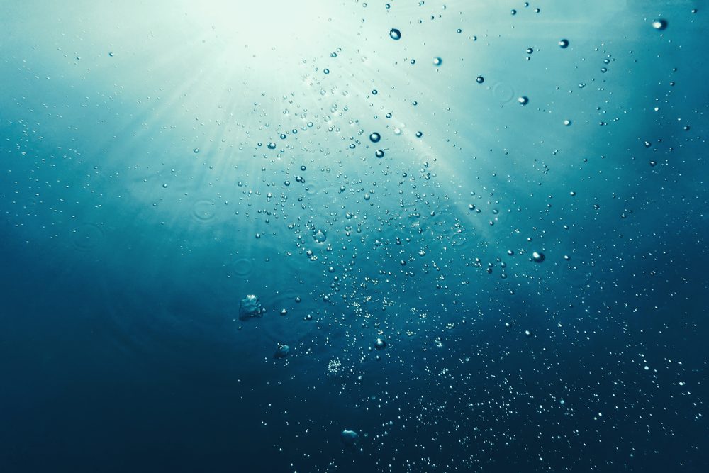 Underwater bubbles with sunlight. Underwater background bubbles.