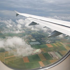 The view form inside the window of an airplane while approaching for landing at the airport of Munich, Germany
