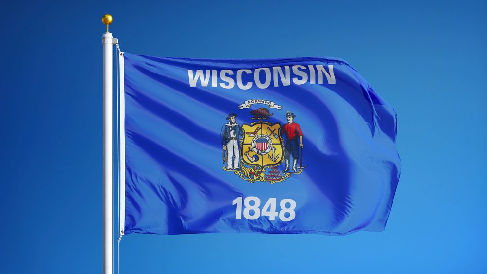Wisconsin (U.S. state) flag waving against clear blue sky, close up, isolated with clipping path mask alpha channel transparency, perfect for film, news, composition