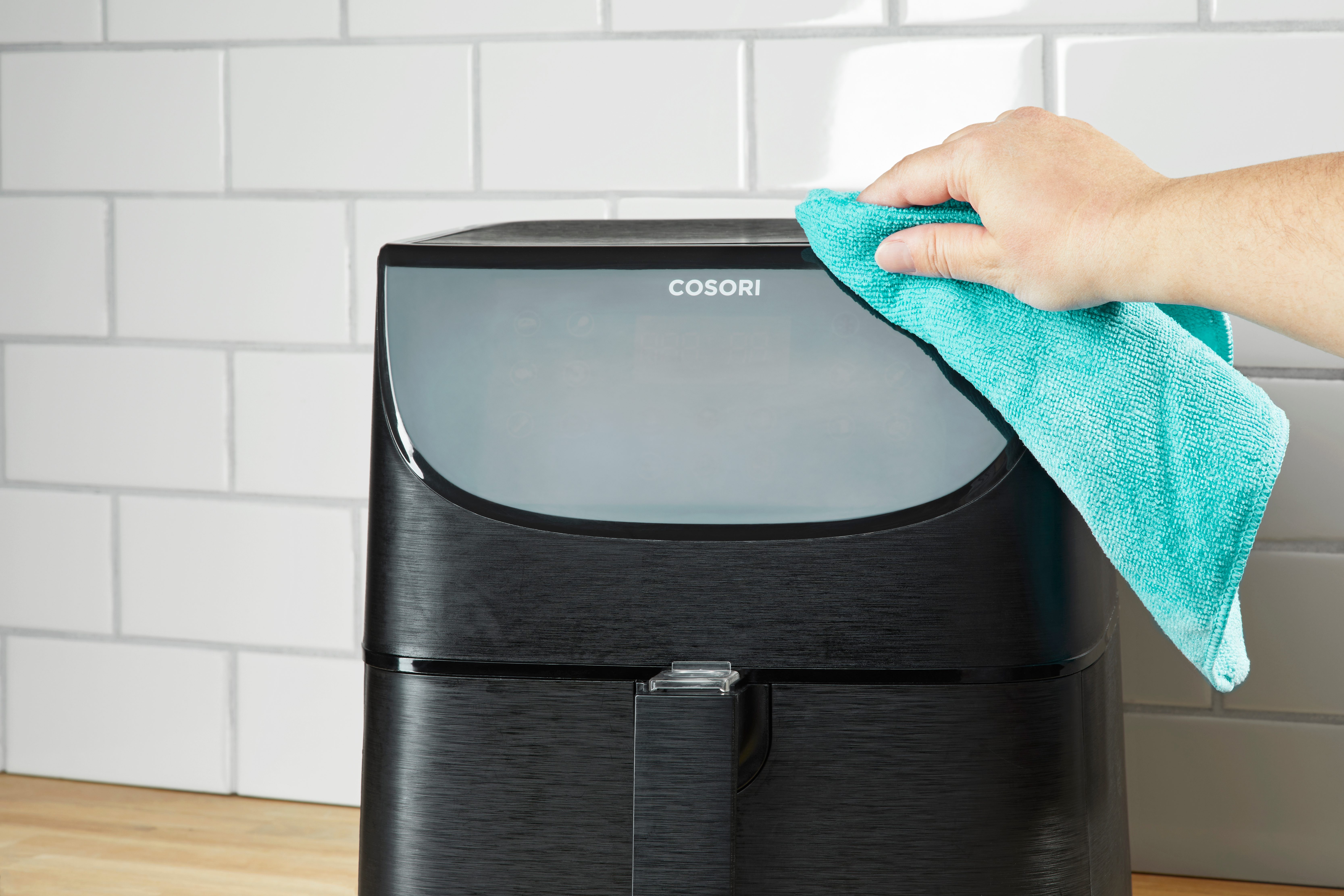 wiping down the exterior of an air fryer