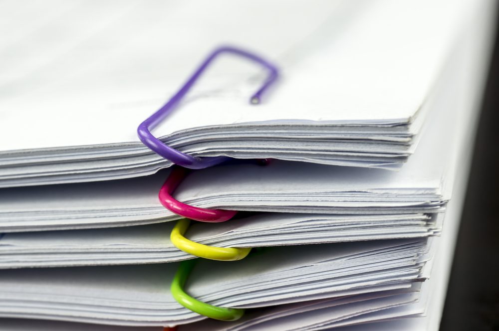 Multicolored paper clips on paperwork