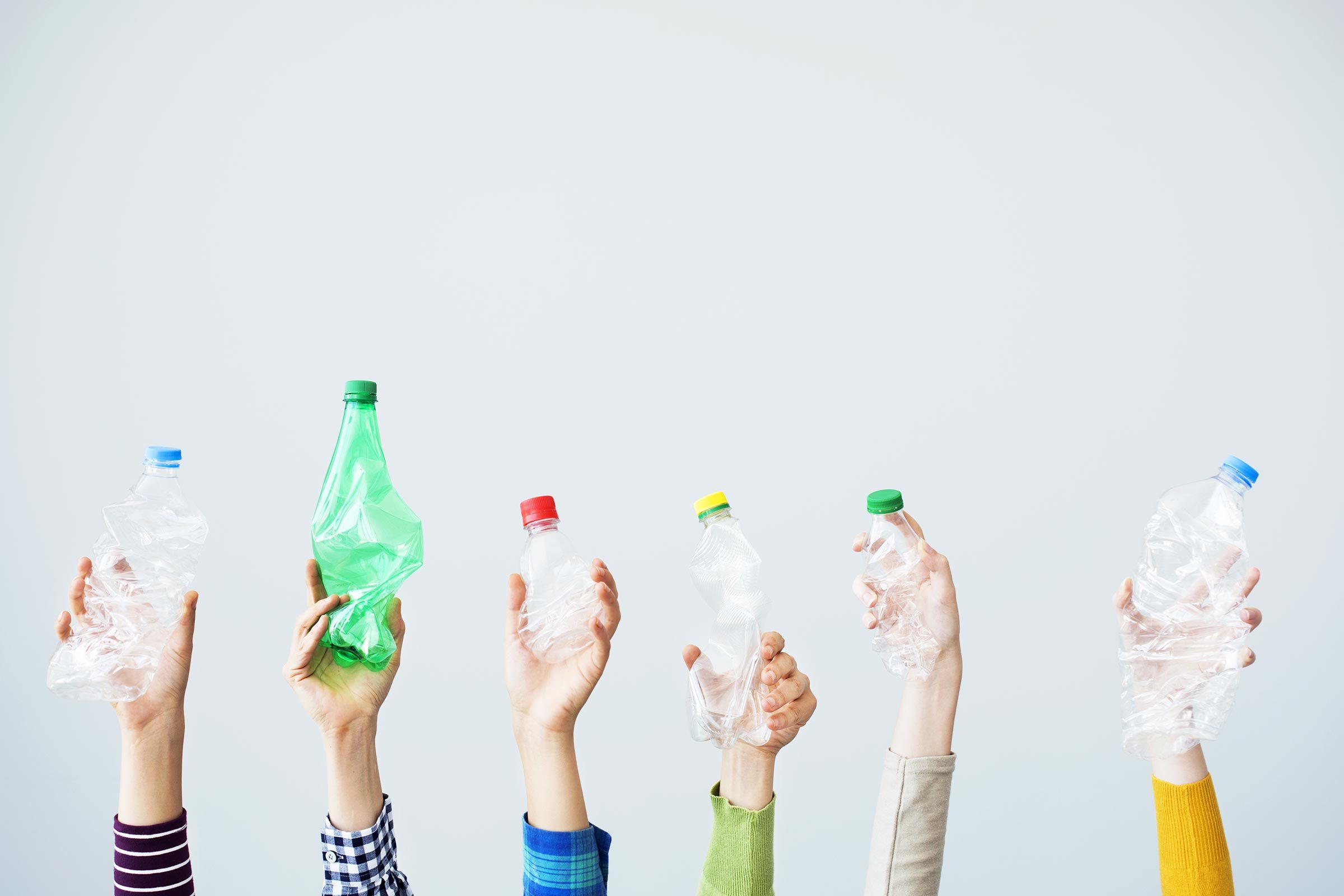 hands holding plastic bottles