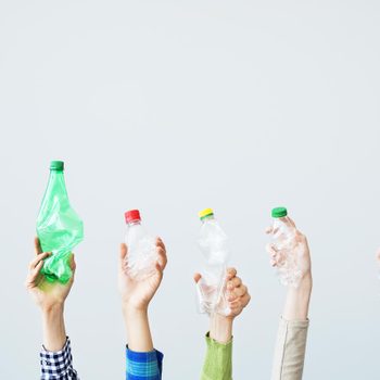 hands holding plastic bottles