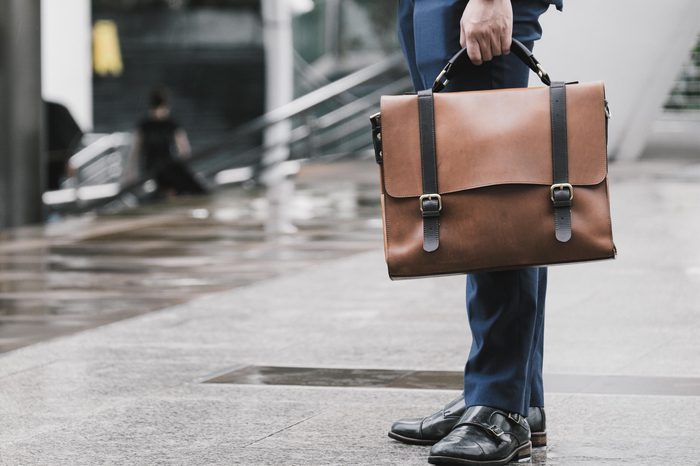 Closeup Of A Businessman Holding leather Briefcase Going To Work