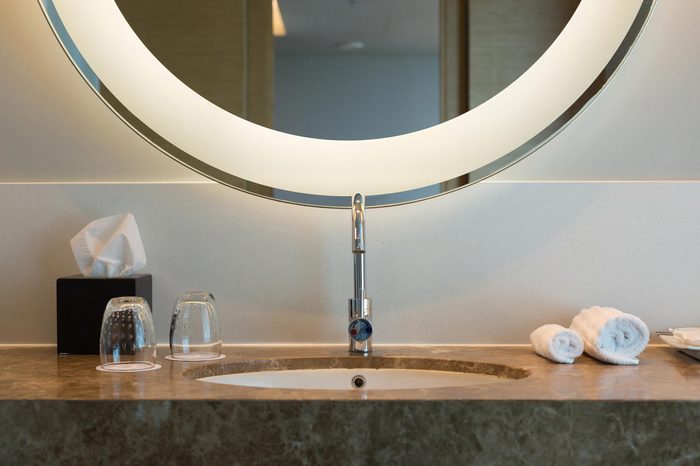 Sink in Bathroom with Towels on Granite Counter