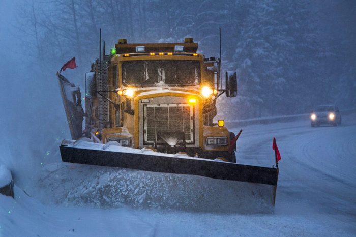 snow plow driving near a plow