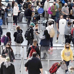 crowded and long lines at a TSA security checkpoint line at Orlando