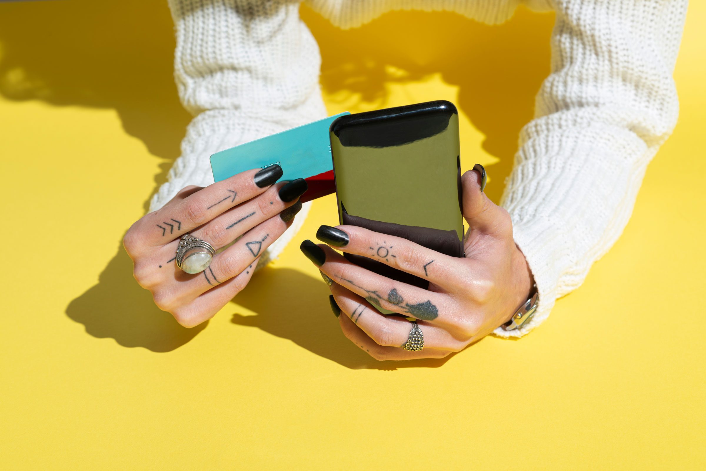 hands holding a phone and credit card online shopping