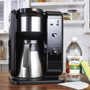 Coffee Maker And Cleaning Supplies on kitchen counter