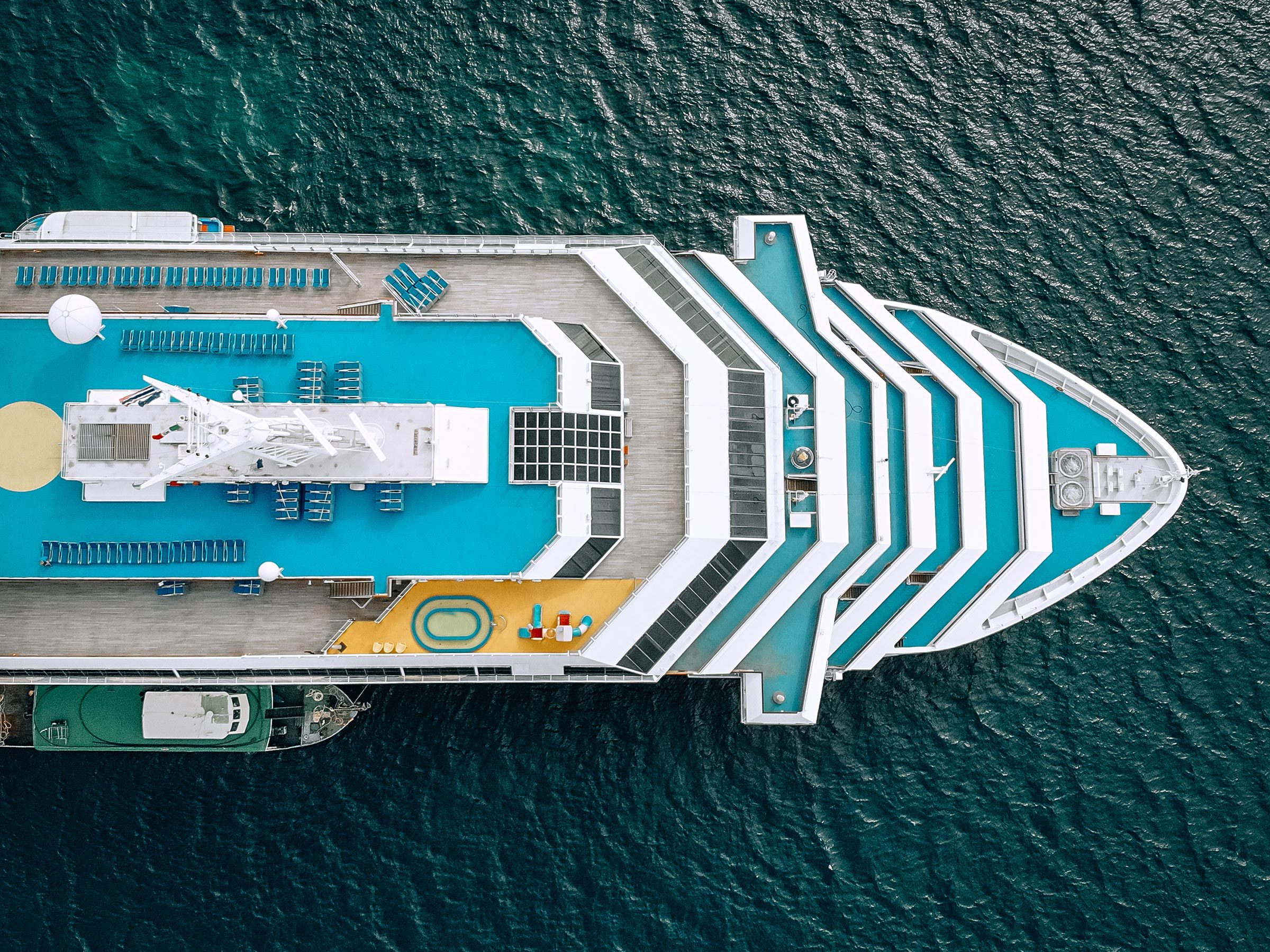 Nose of the blue cruise ship in the sea - top view. The Andaman sea - Aerial image. Beautiful sea landscape