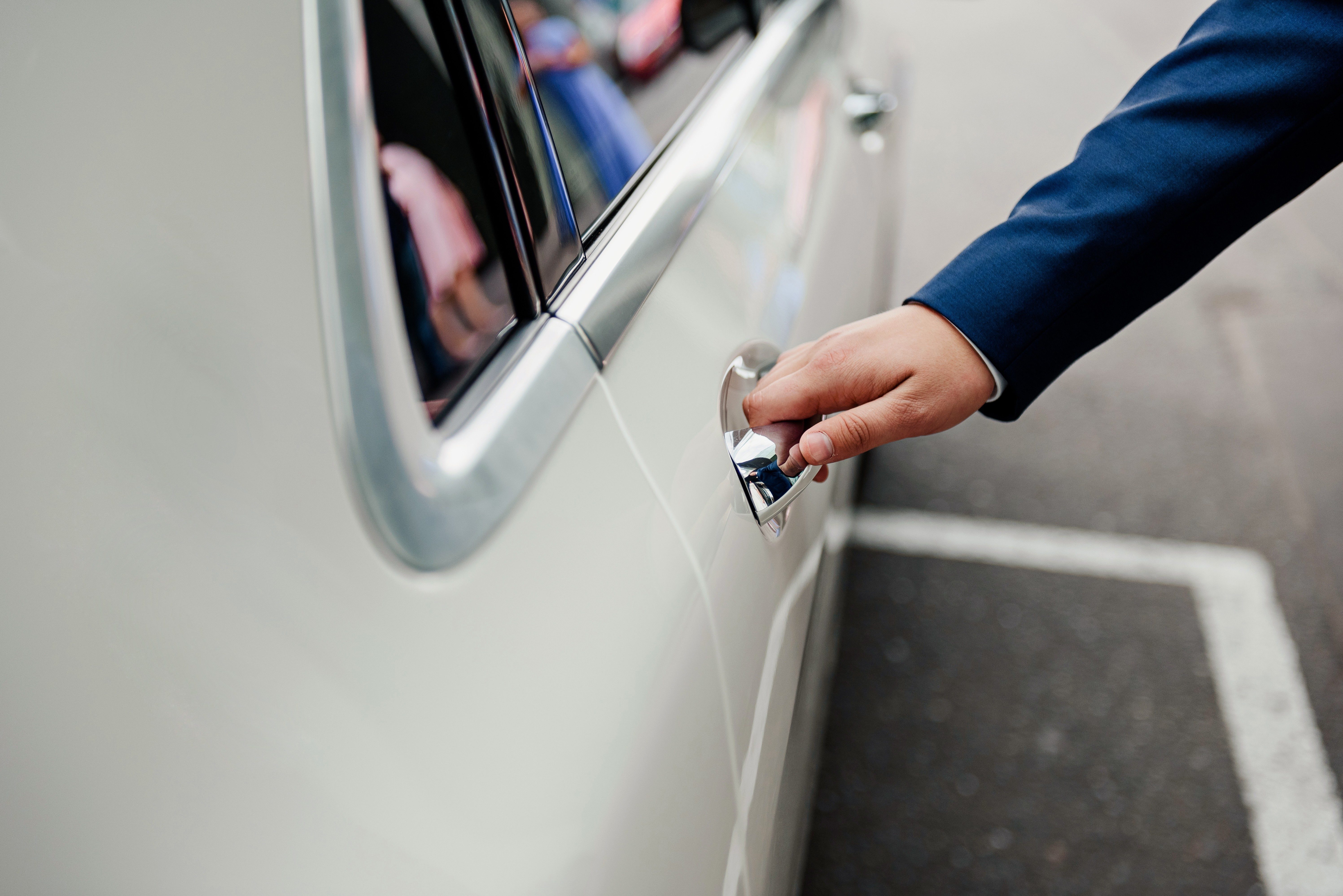 The groom opens the car door