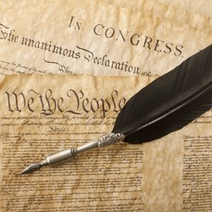 The Constitution for the United States of America with a quill pen