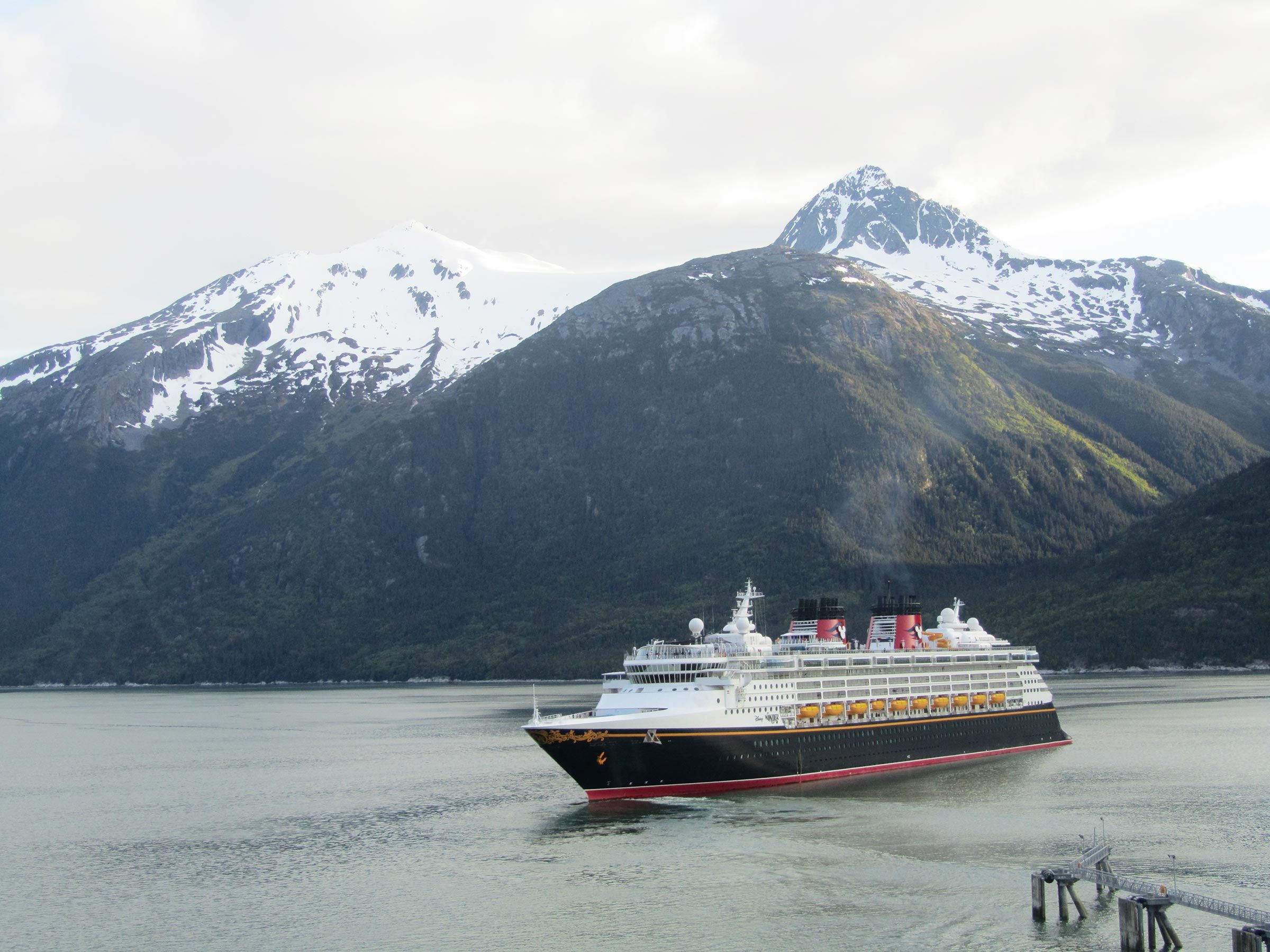 Juneau, Alaska, USA on 05.06.2018: Disney Wonder in front of the fantastic Alaskan scenery