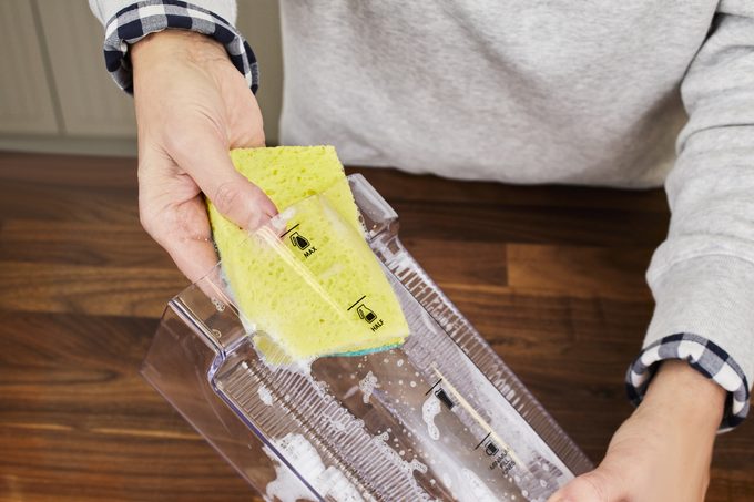 Washing Coffee Maker water container with soap and water