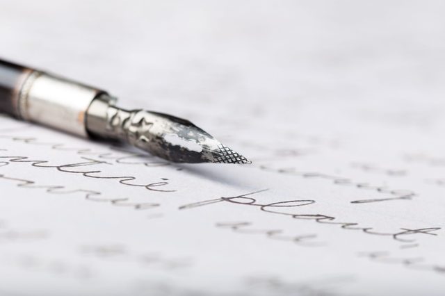 Fountain pen on an antique handwritten letter