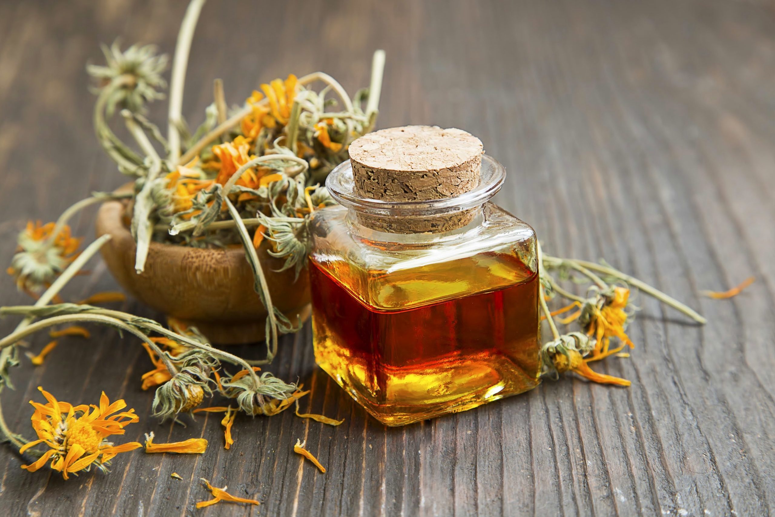 Calendula oil bottle with dried flowers