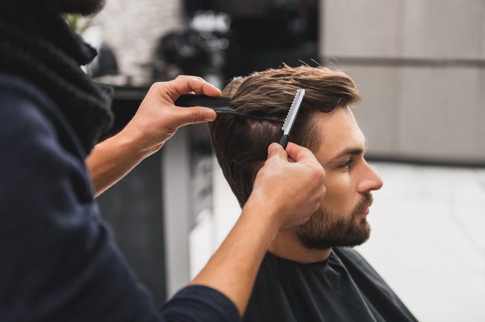 Male client getting haircut by hairdresser