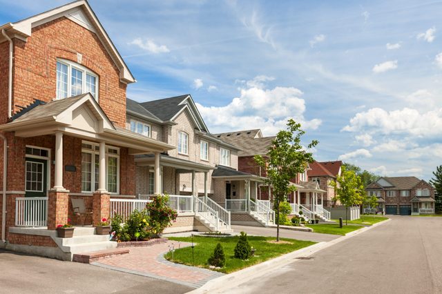 Suburban residential street with red brick houses