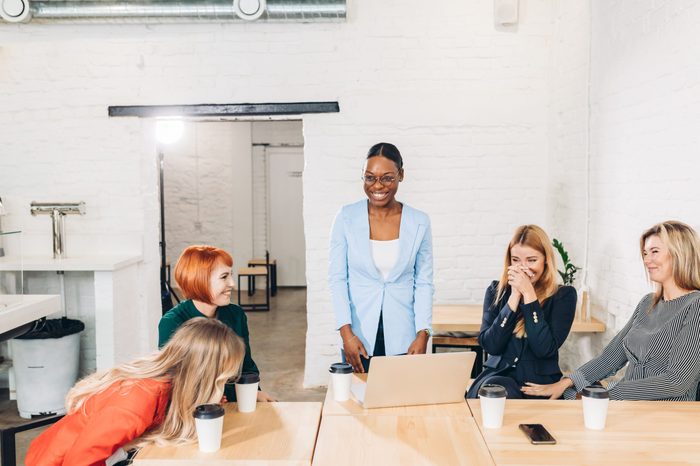 African young beautiful woman in blue formal wear making good first impression at meeting with new partners, women in business