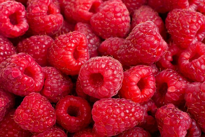 Background of ripe red raspberries, close up