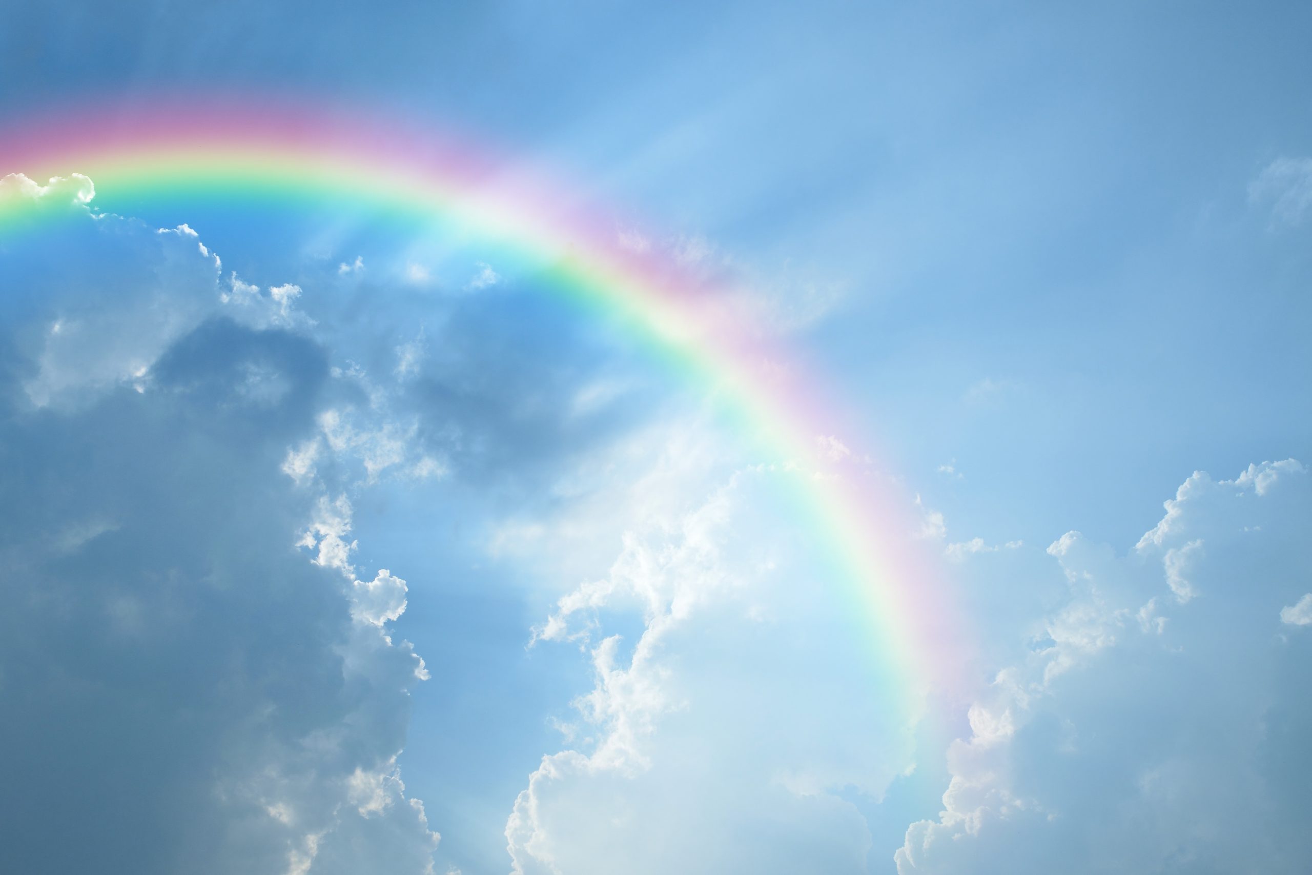 Blue sky and white cloud with sun light and rainbow