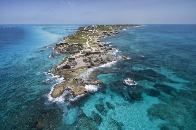 Isla Mujeres, Aerial View Punta Sur.   Crystal clear turquoise water,  waves crashing on the rocky shore, and the ruins of the temple of Ixchel.  