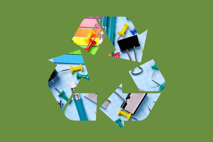 office supplies in a recycle symbol on a green background