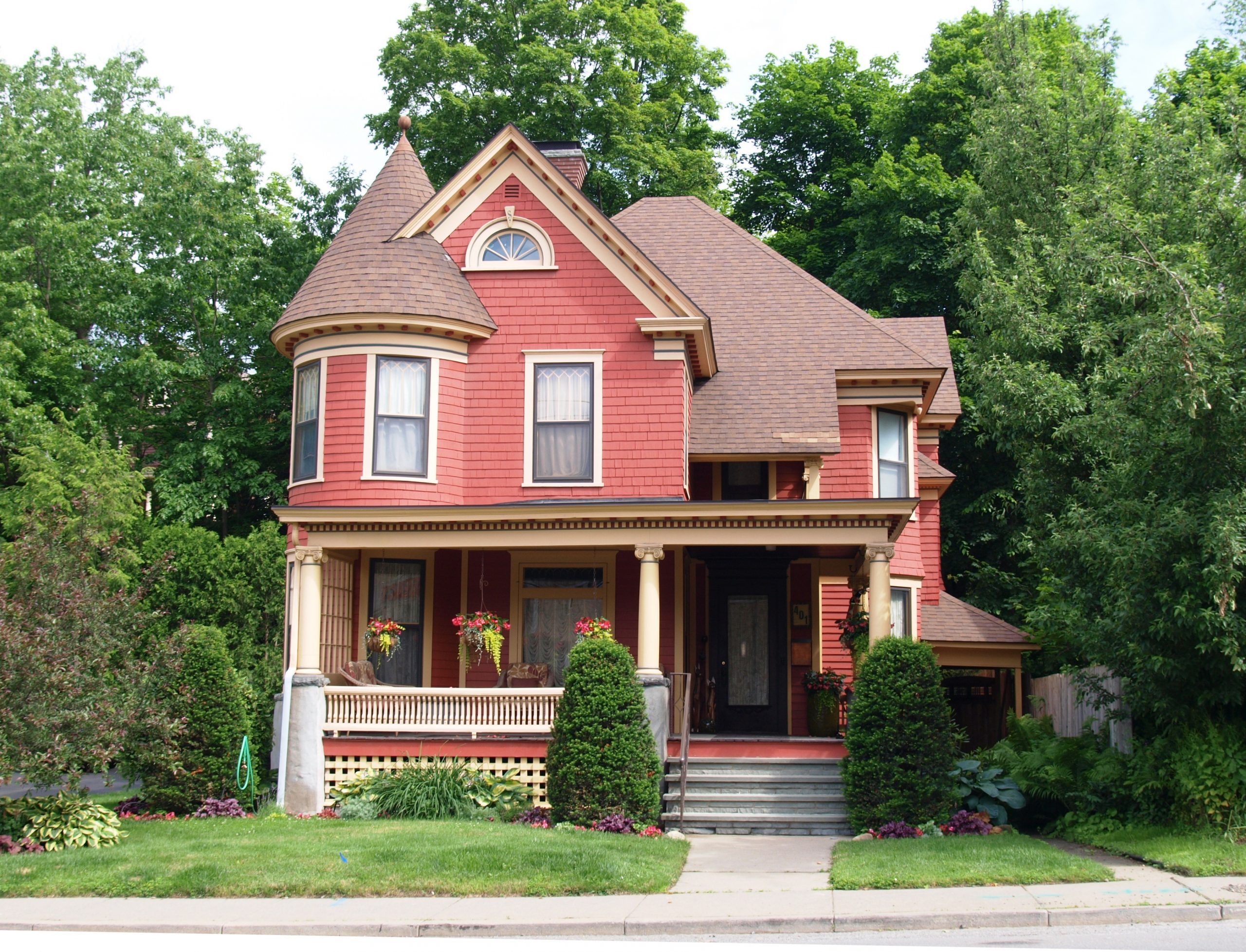 Beautiful Queen Anne style Victorian house surrounded by mature trees