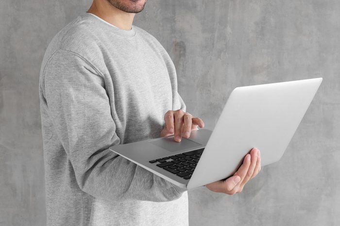 man holding laptop