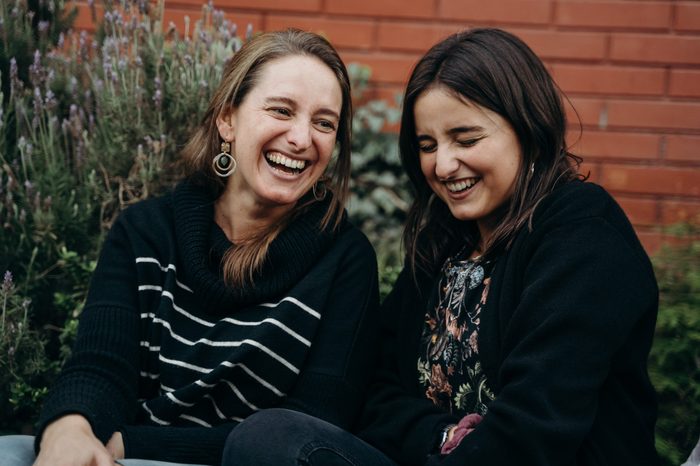 Two sisters laughing out loud