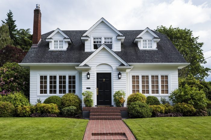 Classic white clapboard house with the red brick sidewalk