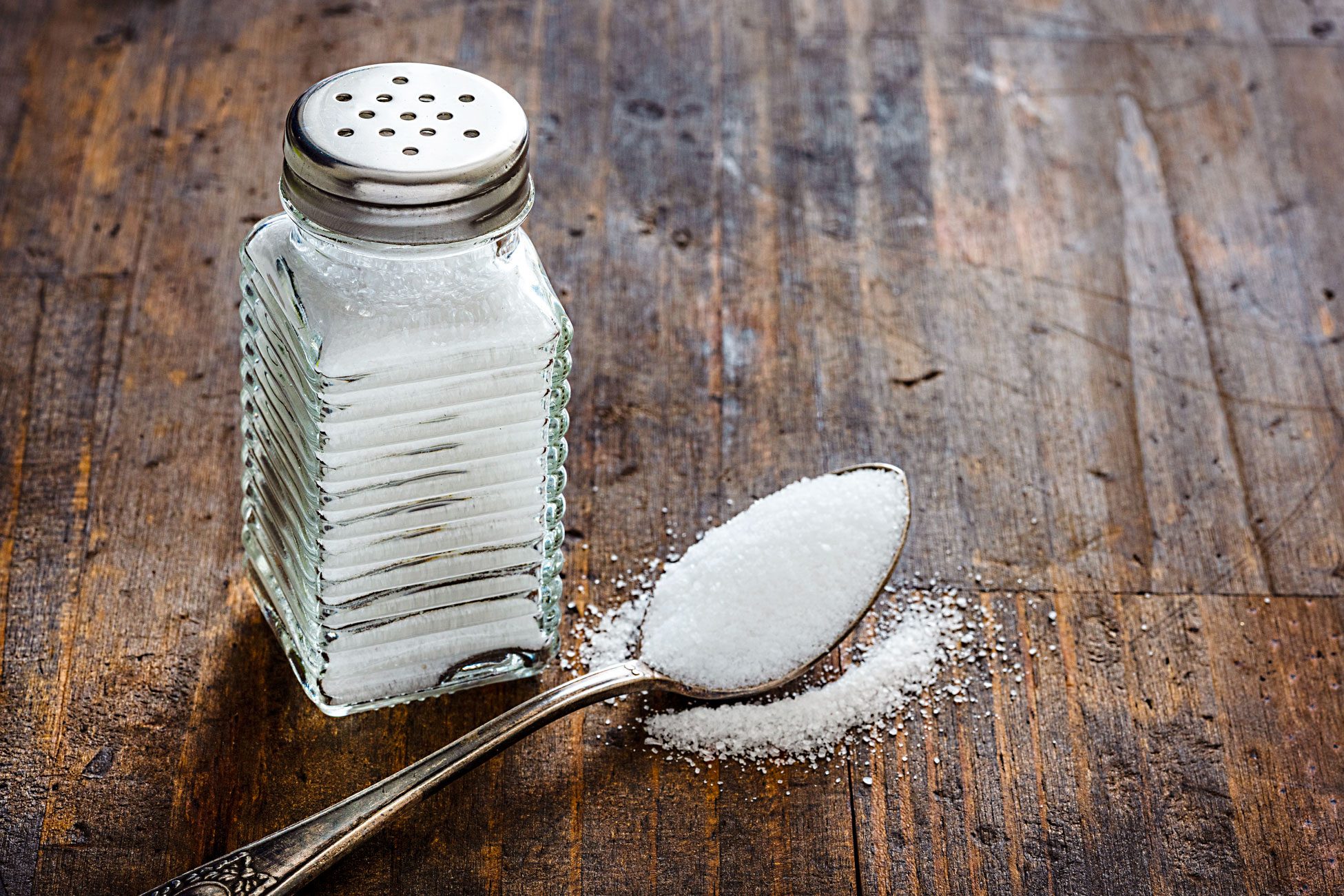 Salt Shaker On Rustic Wooden Table. Copy Space.