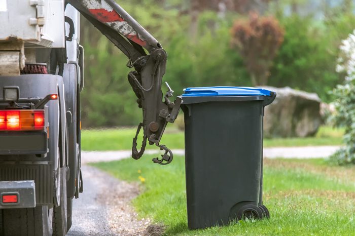 Municipal waste disposal. With a special car garbage truck, the garbage from the garbage bin is loaded into the car. Concept: Waste disposal and cleanliness