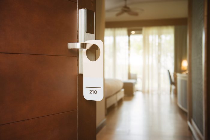 The hotel room with Room Number sign on the door