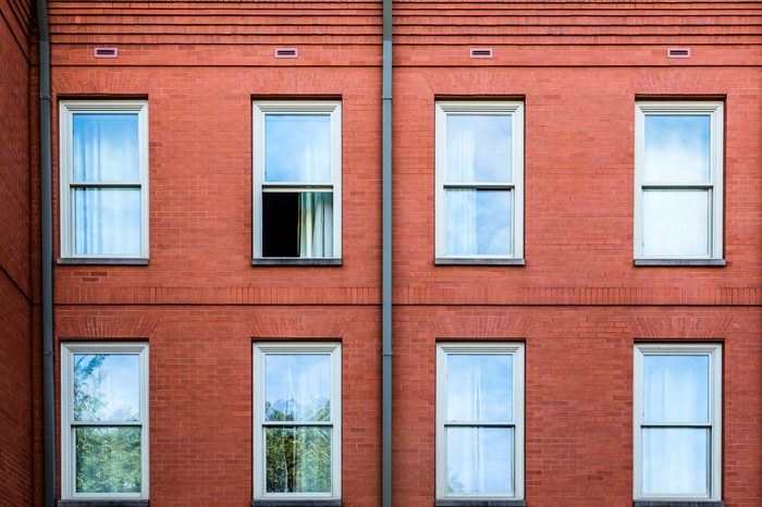 An old brick wall with one window open