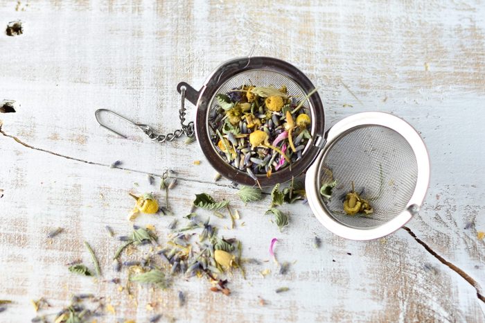 Lavender and Chamomile loose tea herbs on white wash wooden background