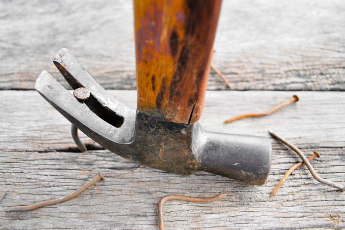 Carpenter Pulling a Nail on wood