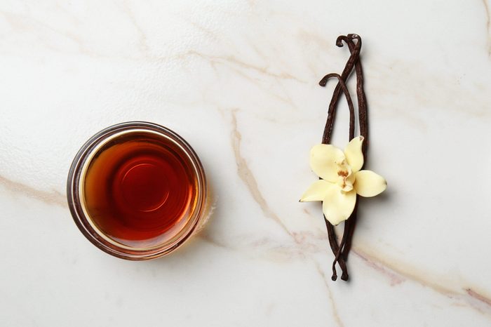 Composition with vanilla extract and sugar on table