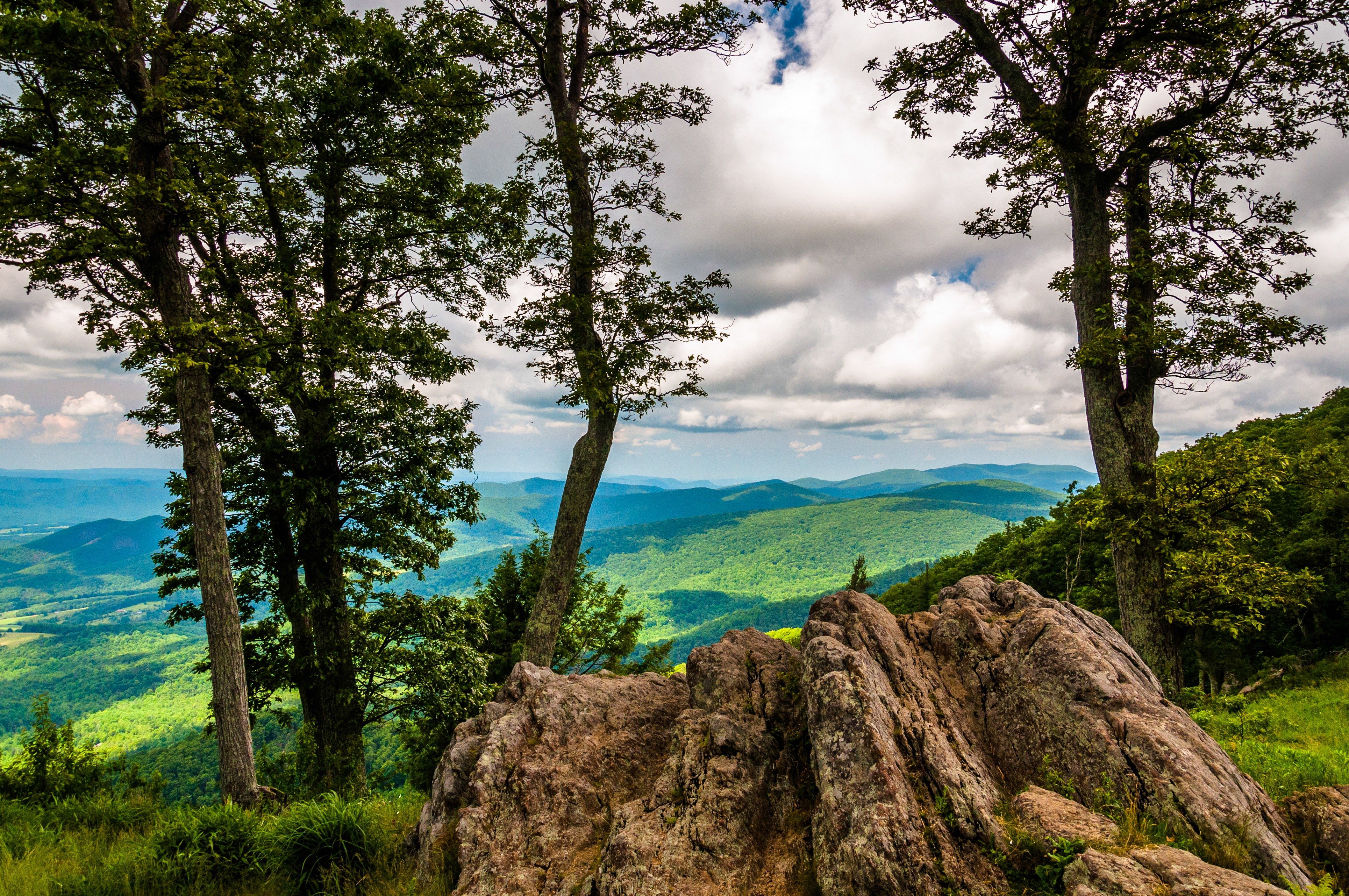 Boulders, trees, and view of the Blue Ridge at an overlook on Skyline Drive in Shenandoah National Park, Virginia.