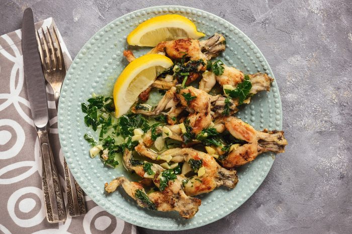 Frog legs baked with garlic butter and parsley.