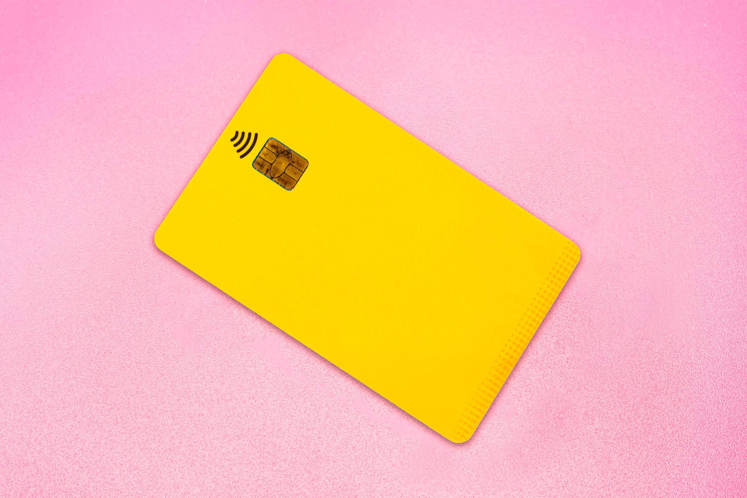 yellow credit card on pink background