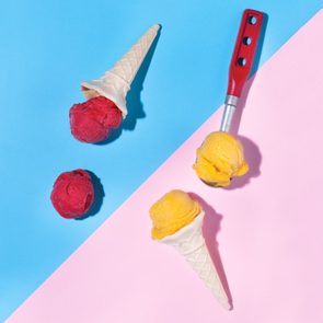 scoops of sorbet and sherbet on blue and pink background with ice cream cones and dessert scoop