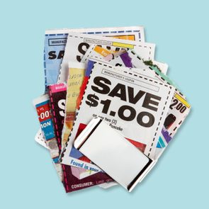 clipped coupons in a money clip on a light blue background