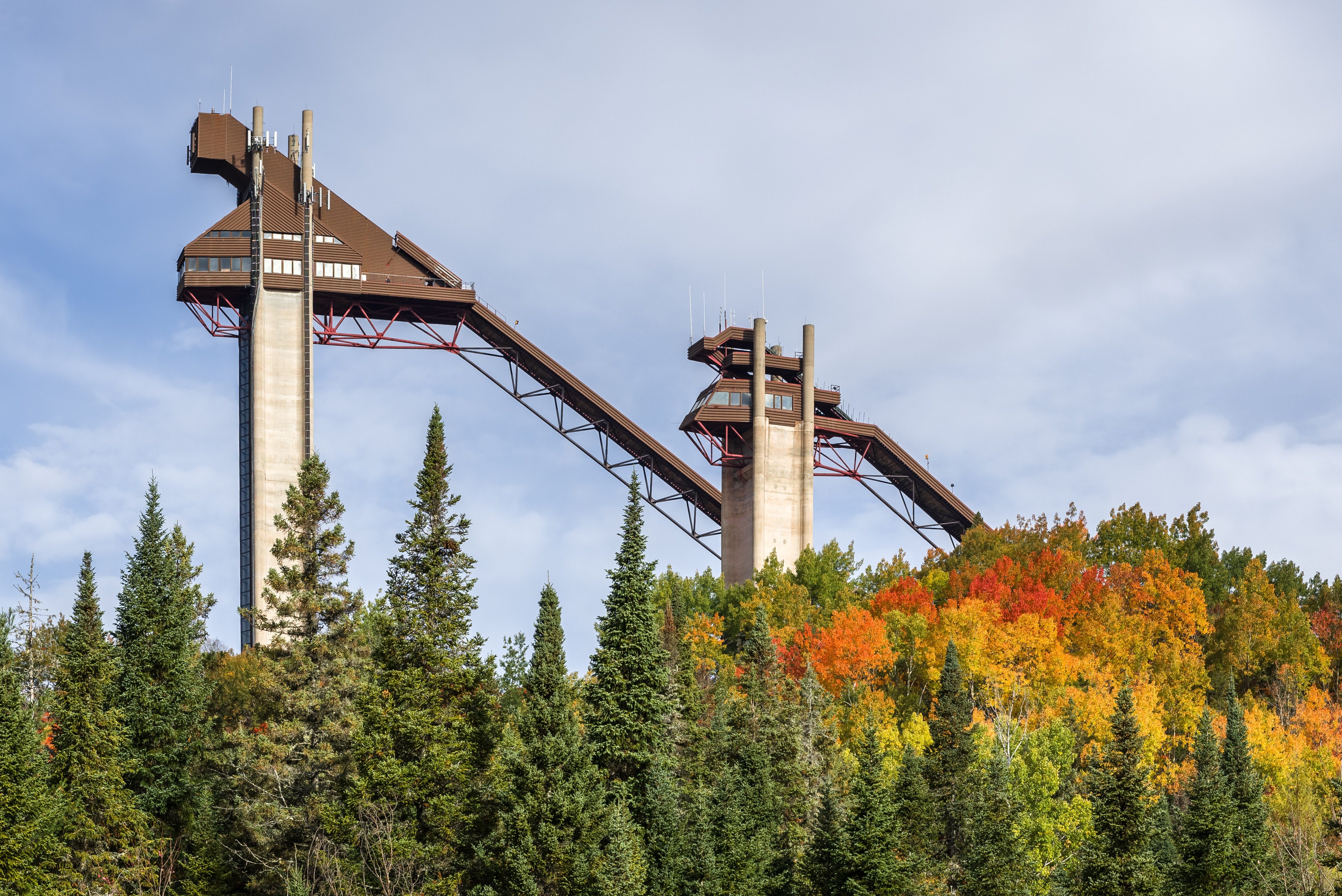 Ski jumps at Lake Placid, NY on a sunny, autumn day with colorful fall foliage