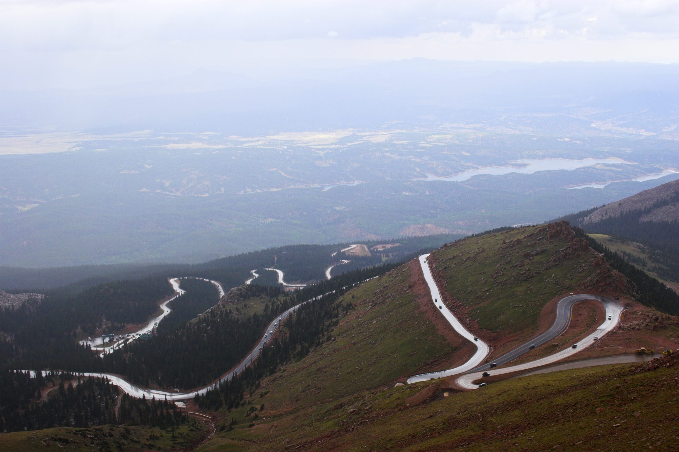 Winding road to Pike’s Peak in Colorado surrounded by colorful mountain prairies during drizzle rain