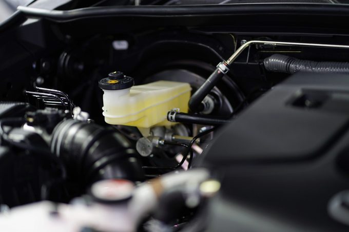 Close up of brake fluid tank inside the car engine.