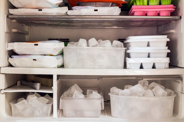 Freezer full of ice cubes and frozen food