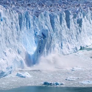 Glacial ice calving with massive ice blacks crashing into the water - 2018 