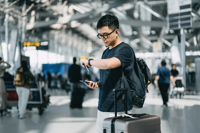 man checking his watch at an airport